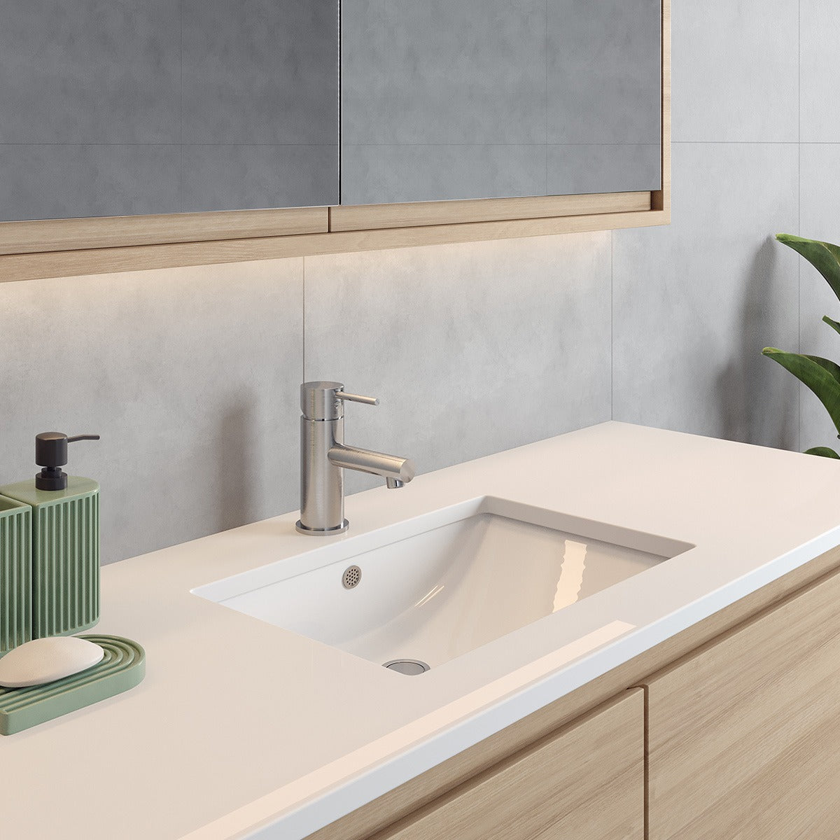 Raymor white rectangular under counter basin installed in a stone vanity with chrome mixer tap￼