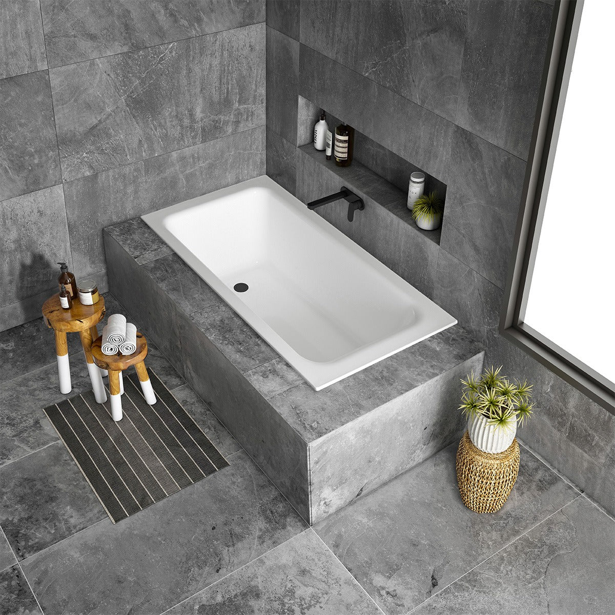 Raymor Sigma white inset bath in a grey tiled bathroom, rectangular tile flange bath with end waste and black wall mixer