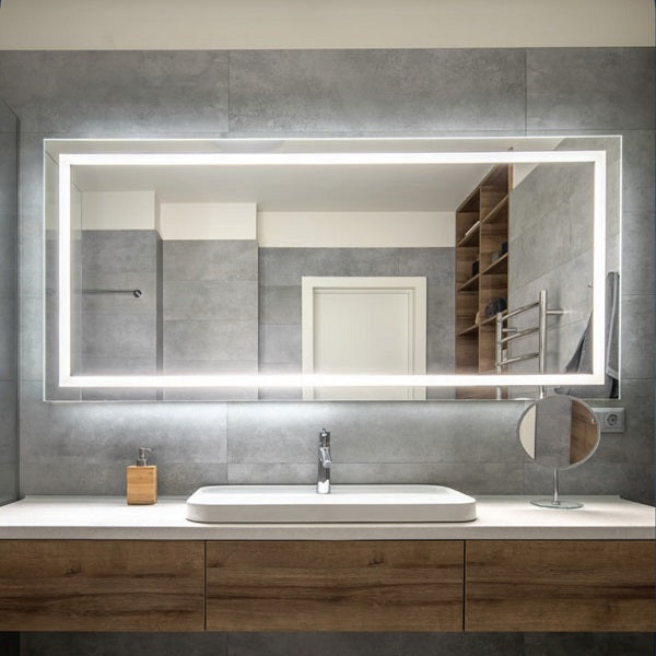 Thermogroup rectangular LED backlit bathroom mirror in cool white light above a vanity, landscape mounted