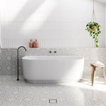 Bao Elegant matte white back to wall bath, oval acrylic tub with centre waste in tiled bathroom setting