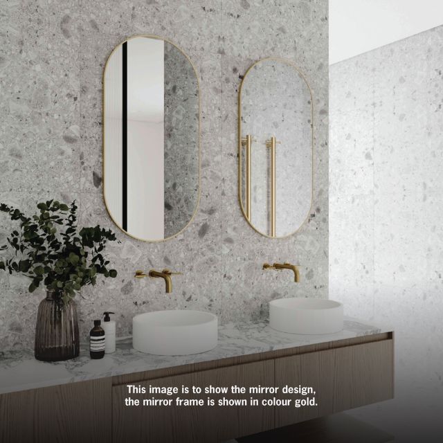 Two Thermogroup pill-shaped framed mirrors in gold above a double vanity, shown in a bathroom setting; black frame variant noted in title