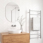 Thermogroup pill shape polished edge mirror above a vanity, with towel ladder reflected in the bathroom scene
