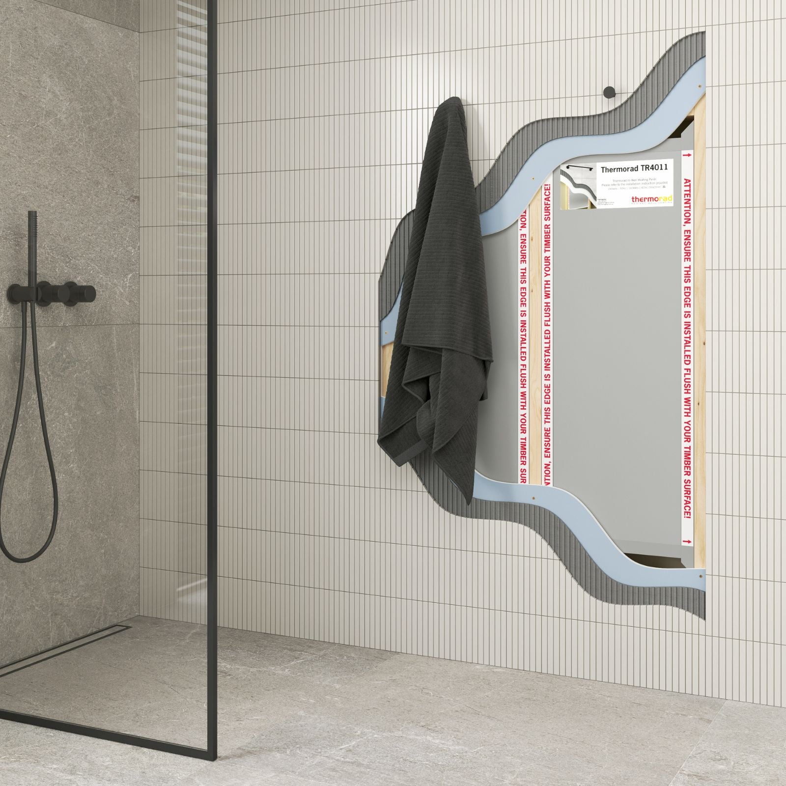Thermogroup Thermorad in-wall heated towel dryer installed in a tiled bathroom, shown with towels and cutaway cavity viewing detail