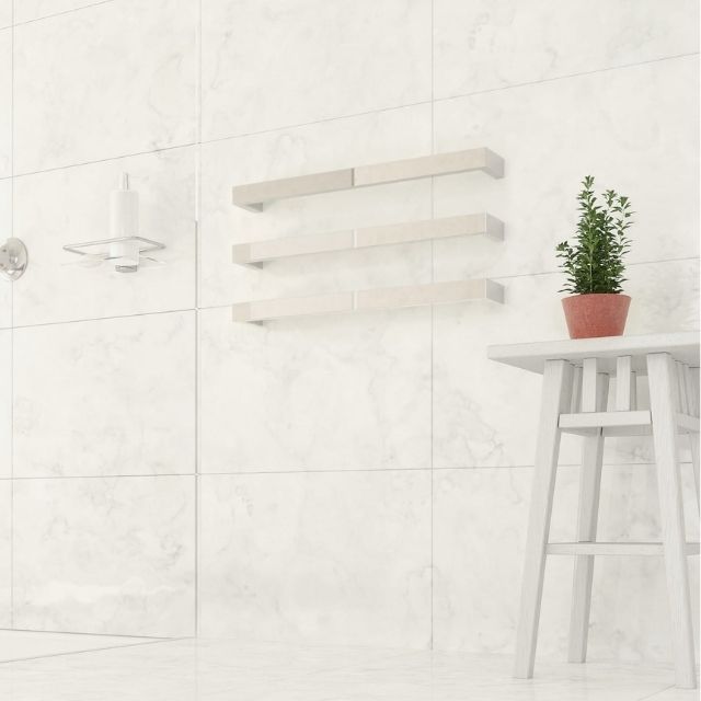 Thermogroup Thermorail square single heated towel rail in polished stainless steel on a white tiled bathroom wall