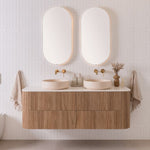 ADP Thirroul wall hung vanity with curved timber-look front, white benchtop and twin oval basins in a bathroom setting