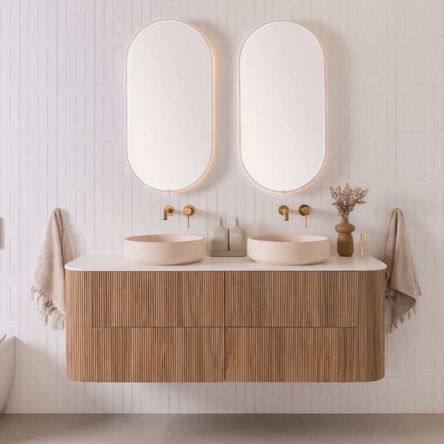 ADP Thirroul wall hung vanity with curved timber-look front, white benchtop and twin oval basins in a bathroom setting