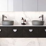 Timberline Allure grey round above counter basin on a bathroom vanity, with black tapware and marble-look splashback