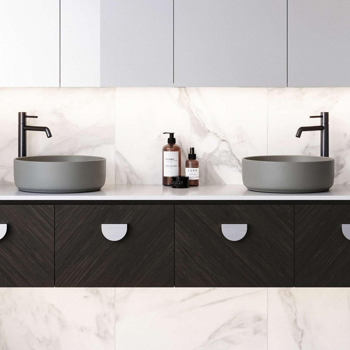 Timberline Allure grey round above counter basin on a bathroom vanity, with black tapware and marble-look splashback