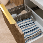 Timberline Santos Apollo fluted vanity drawer with woven basket and folded towels, side view of timber finish and gold handle