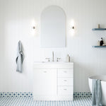 Timberline Bargo floor standing vanity in white with Regal mineral composite top, shown in a bright bathroom setting