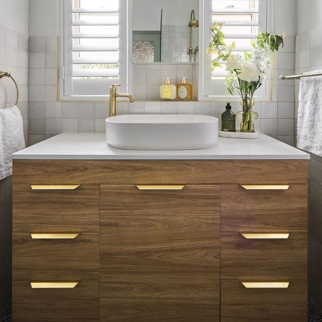 Timberline Bargo floor standing vanity in woodgrain finish with white Silksurface top and basin, front view
