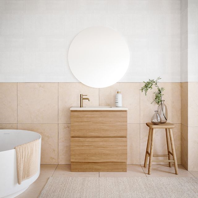 Timberline Billie floor standing ensuite vanity in woodgrain finish with white top and round mirror in a bathroom setting