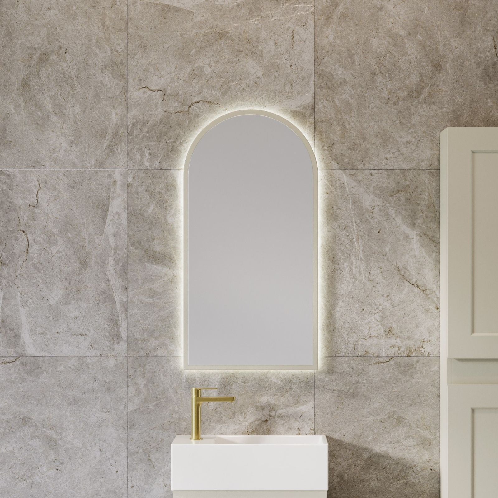 Timberline arched wall mirror with white frame, shown in a bathroom vanity setting against stone-look tiles