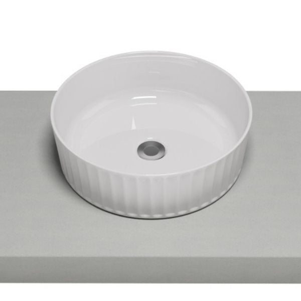 Timberline Allure Flute matte white round above counter basin with fluted outer edge on a vanity top, angled view