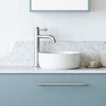 Timberline Gem white round above counter basin on a marble-look vanity with brushed steel tap￼