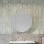 Timberline Havana round shaving cabinet in white, mounted above a bathroom vanity with tiled wall backdrop