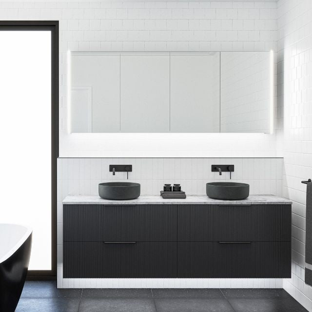 Timberline Henley Dockland wall hung vanity in black satin with fluted front, stone-look top and two above counter basins in bathroom setting