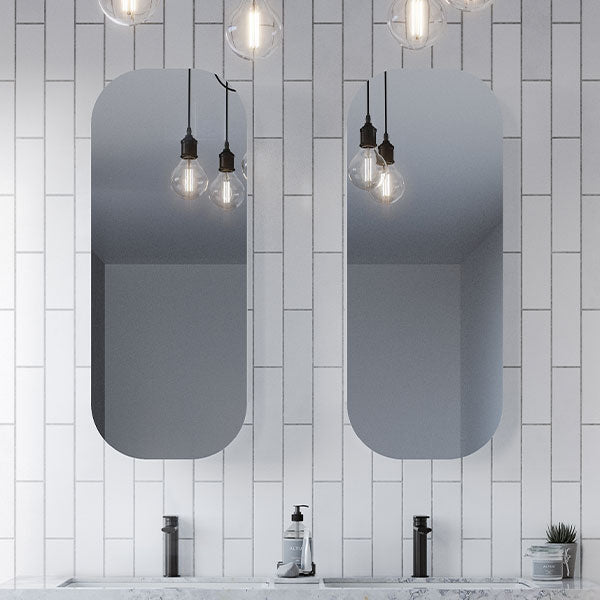 Timberline Jazz Arch Mirror in white satin, shown in a bathroom with two tall arched mirrors above a vanity