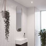 Timberline Jazz Arch Mirror in white satin, tall narrow arched bathroom mirror on patterned wall