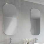 Timberline Jazz Arch Mirror in white satin, shown wall-mounted above a vanity in a bathroom setting