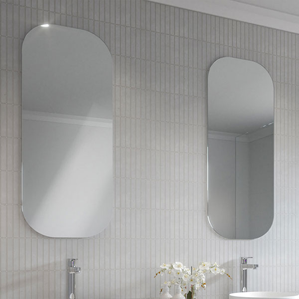 Timberline Jazz Arch Mirror in white satin, shown wall-mounted above a vanity in a bathroom setting