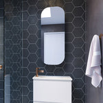 Timberline Jazz Arch Mirror in white satin finish, shown above a bathroom vanity against dark hexagon tiles