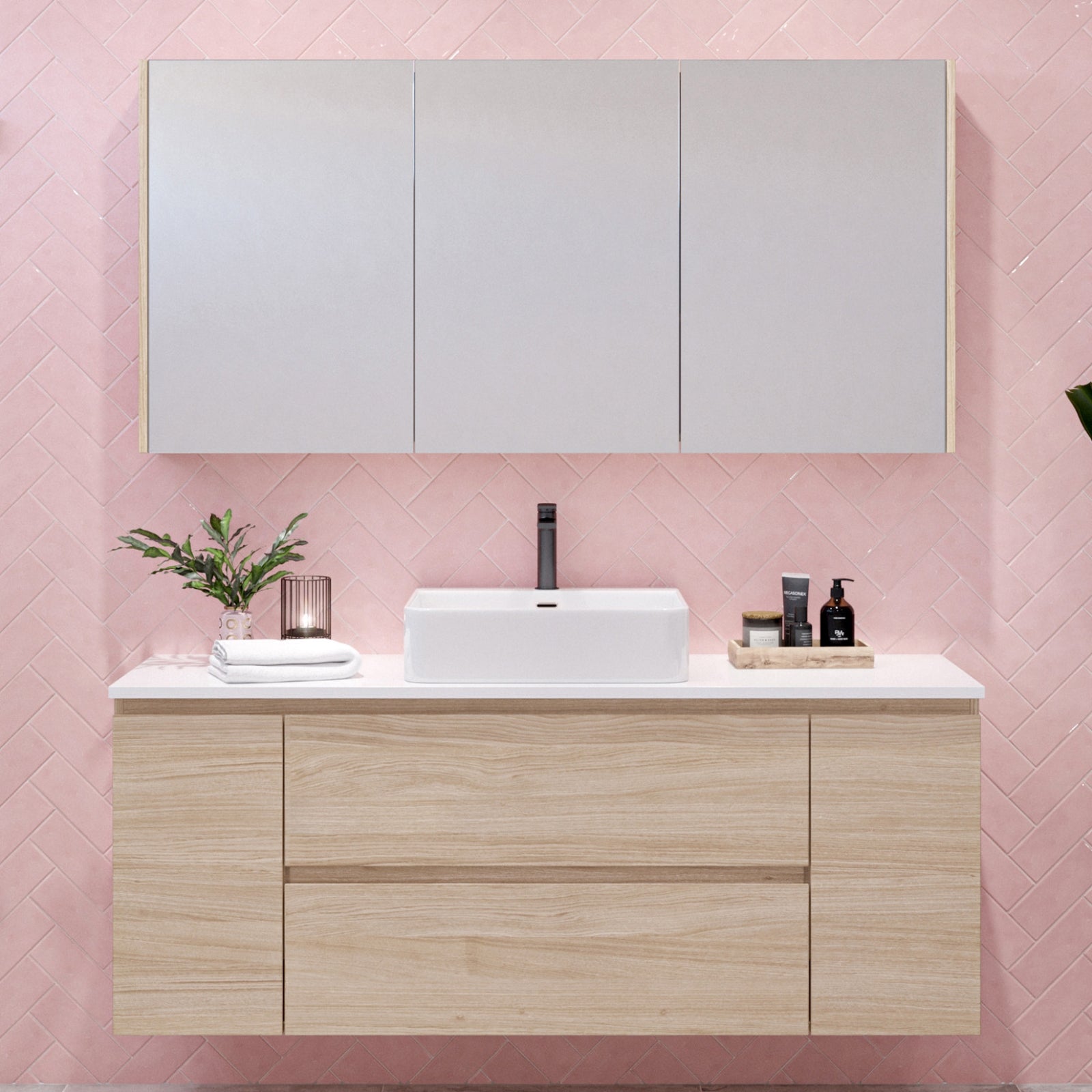 Timberline Marshall wall hung vanity in light oak with white top and basin, shown with matching wall cabinet above pink tiles