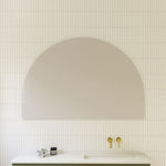 Timberline Melody half-moon mirror with white satin edging above a bathroom vanity, portrait wall-hung view