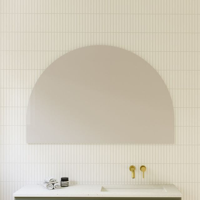 Timberline Melody half-moon mirror with white satin edging above a bathroom vanity, portrait wall-hung view