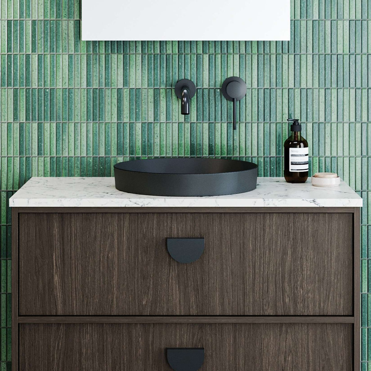 Timberline Radius inset basin in matte black, round above-counter bathroom basin on a vanity with green tiled wall backdrop