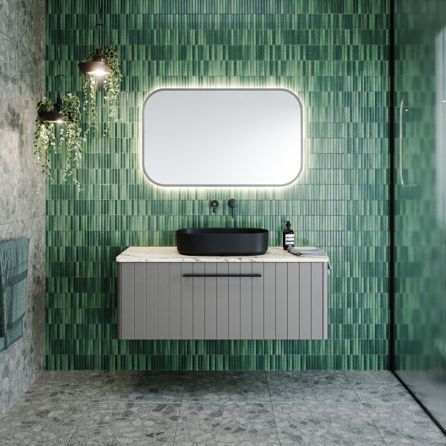 Timberline Saba wall hung vanity in grey with black handle and black above-counter basin in a green tiled bathroom