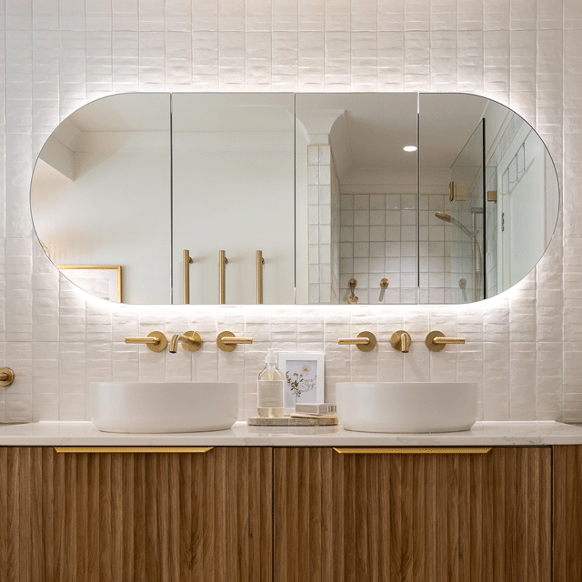 Timberline Ballad oval shaving cabinet with mirrored doors, above a timber vanity in a bathroom setting