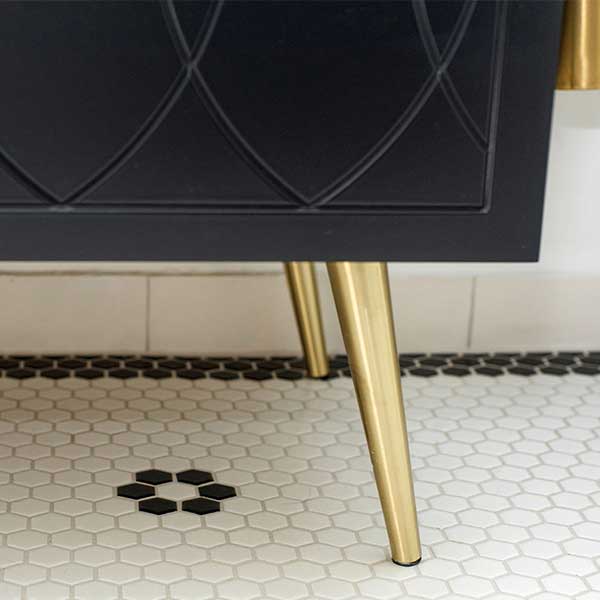 Timberline Sutherland House Deco vanity detail in black with gold legs on white hexagon floor tiles