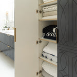 Timberline Sutherland House Deco wall hung storage cabinet, open black door showing white and oak shelves with folded towels