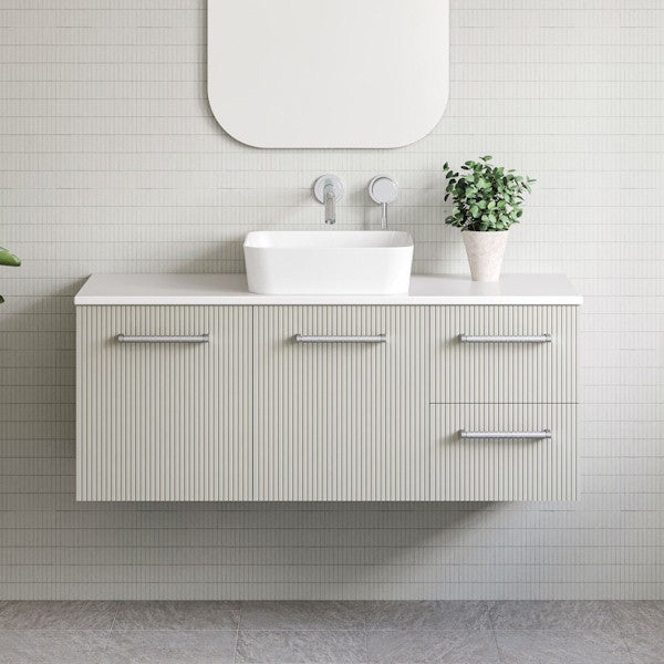Timberline Victoria wall hung vanity with ribbed front, Silksurface top and white above counter basin in bathroom setting