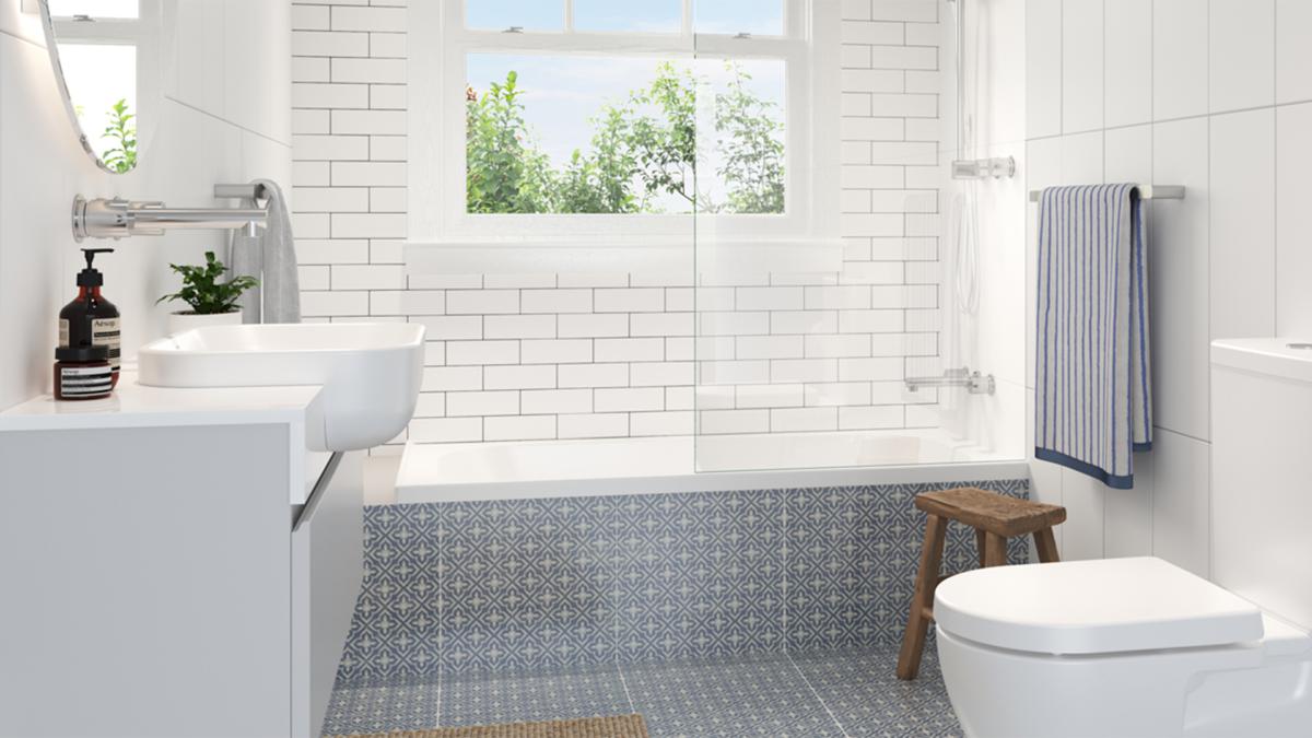 White subway tiled bathroom with timber vanity, Caroma Luna toilet suite and semi recessed basin