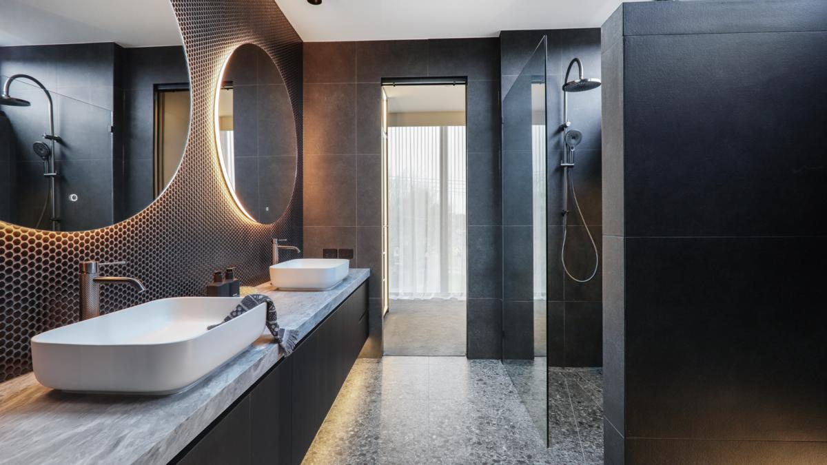 Dark stone bathroom with Nero Mecca brushed bronze shower, rectangle basin and Aulic Windsor LED mirror