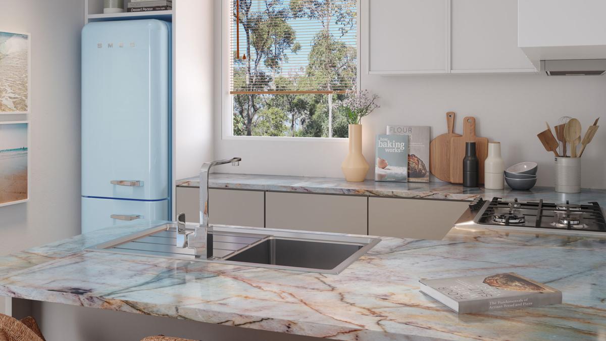 Kitchen with retro blue fridge, bold marble bench and chrome sink mixer