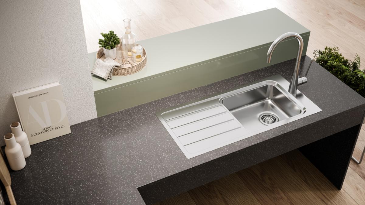 Dark stone kitchen bench with stainless steel sink and drainer and chrome mixer