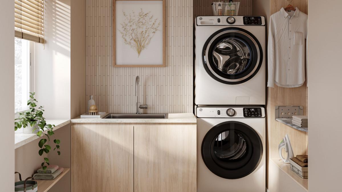 Compact laundry with stacked washer and dryer, timber benchtop and chrome mixer