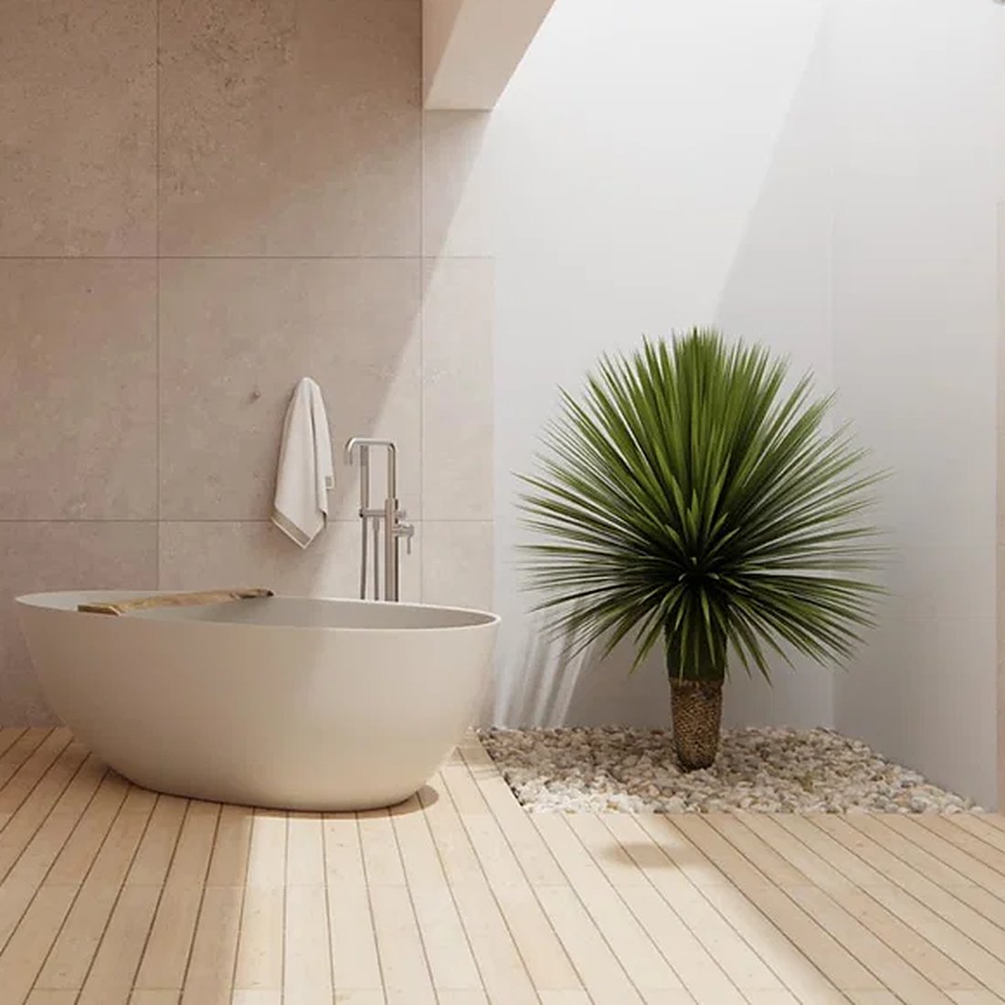 Outdoor bathroom with a freestanding stone bath, floor-mounted bath filler and a yucca on pebbles, beside a timber deck