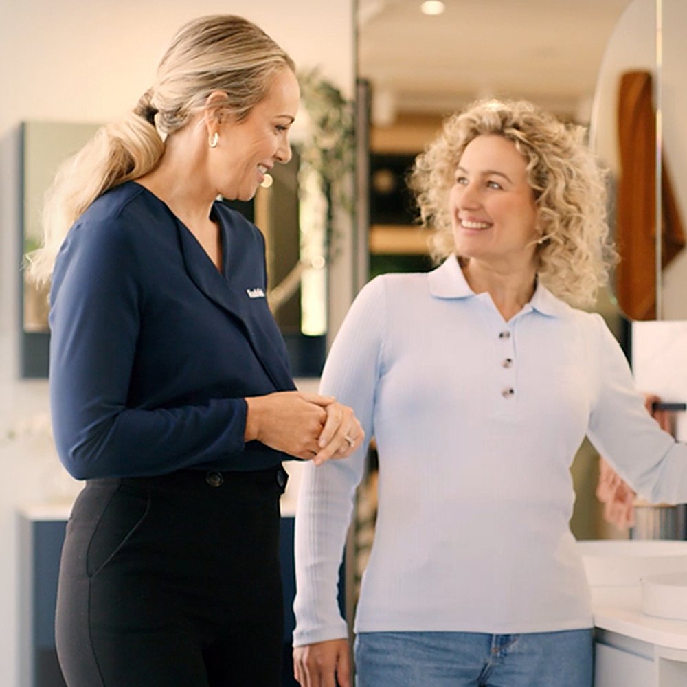 Two Tradelink team members talking with each other in a Tradelink showroom