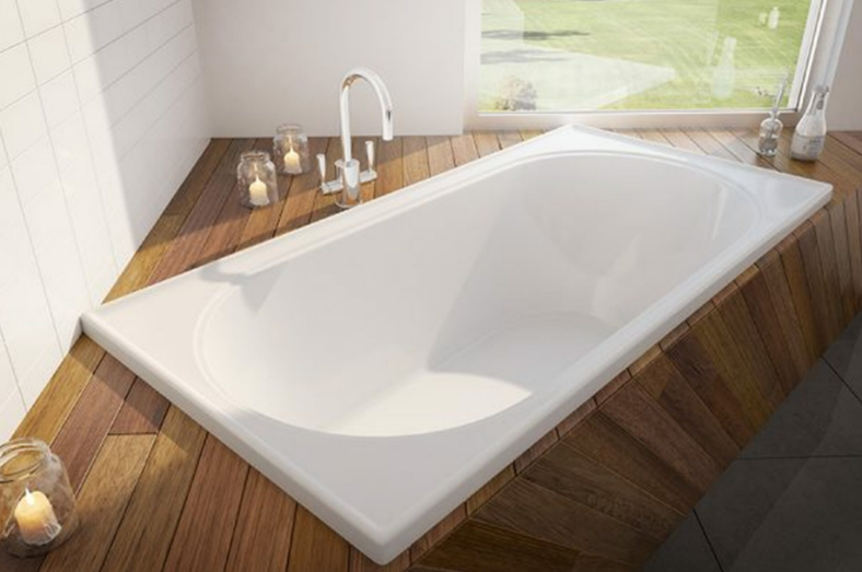 White inset bath with wood highlights and chrome bathtub mixer