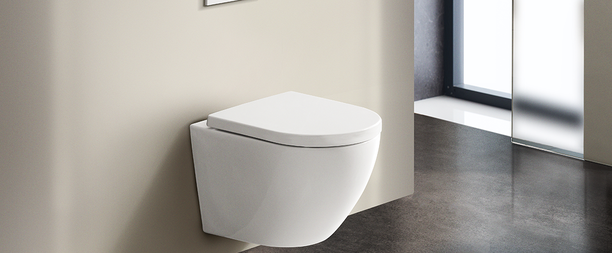 Image featuring a rimless white toilet against a neutral coloured wall