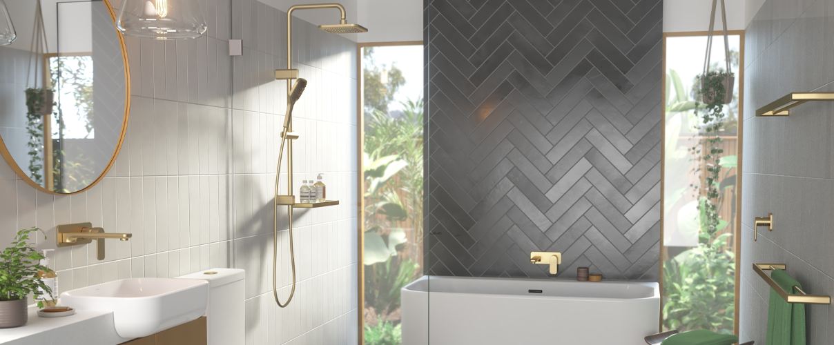 Dark grey herringbone bathroom feature wall with while basin and bath as well as gold tapware and shower