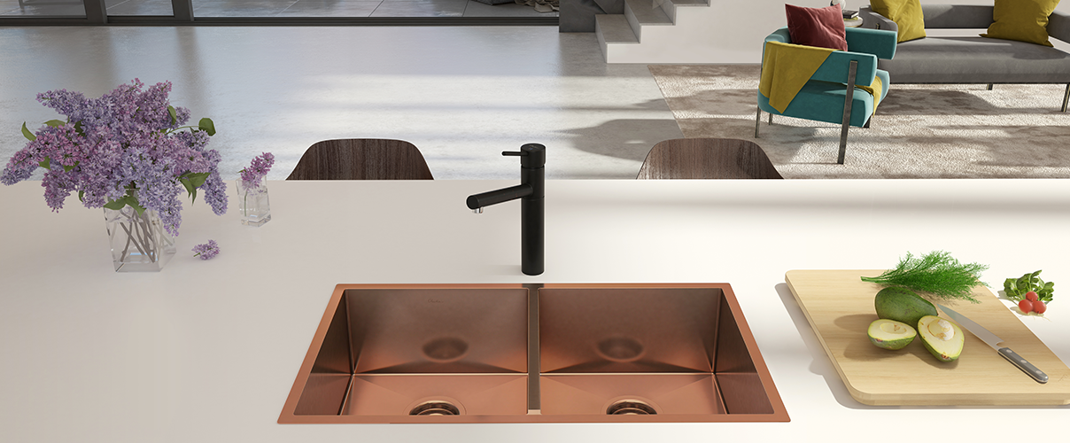 Grey kitchen island with a copper sink and black tapware