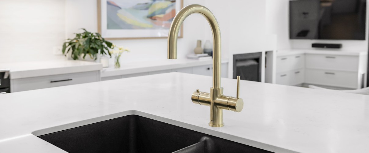 Gold kitchen mixer with filer water capacity and black kitchen sink