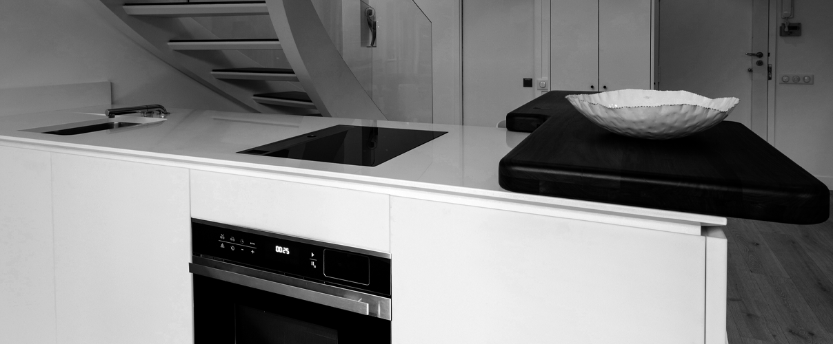 Black and white kitchen with black appliances