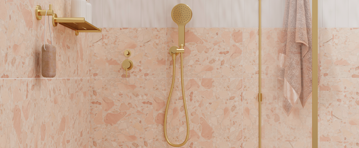 Peach coloured shower with gold tapware and fixtures
