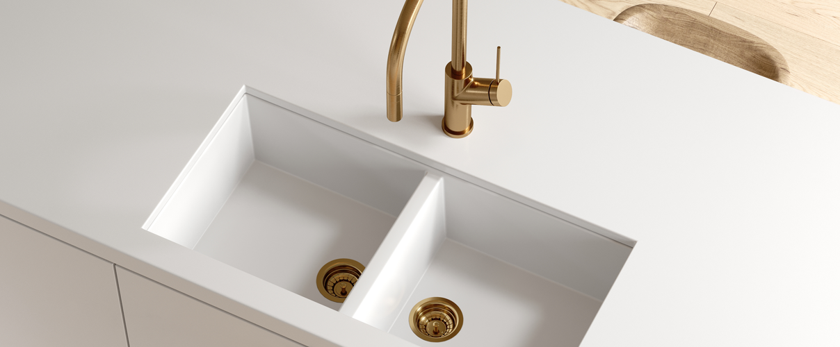 White kitchen counter and sink with gold mixer